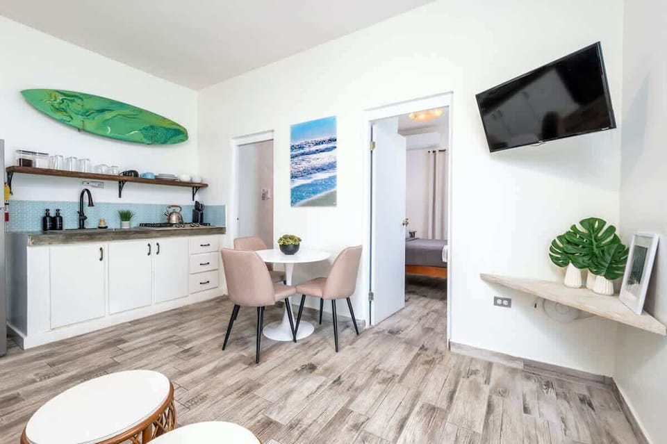 Bright studio in Rincón, Puerto Rico — surf-inspired decor, modern kitchen, and cozy dining for relaxed island living.