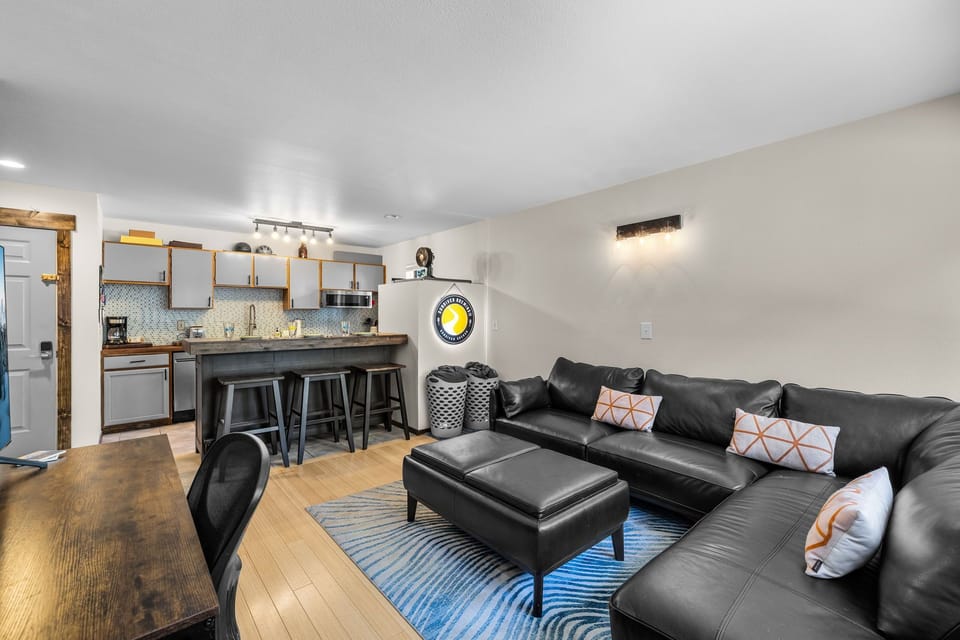 Relax in your stylish open-concept space where the plush leather sectional invites movie nights while the modern kitchen awaits your culinary adventures.