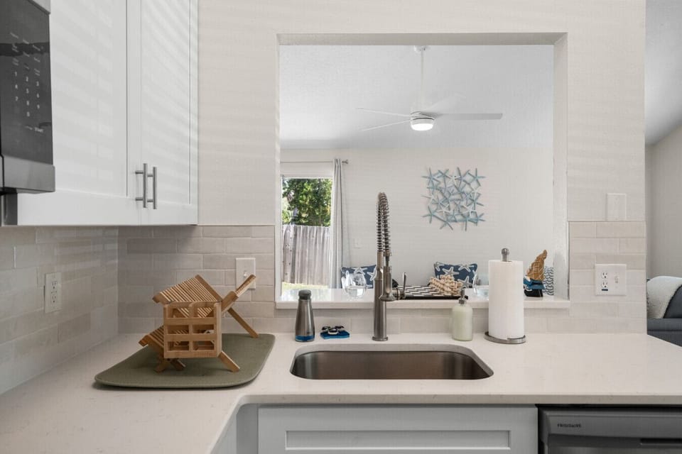 A cozy two-seater breakfast bar connects the kitchen and living room