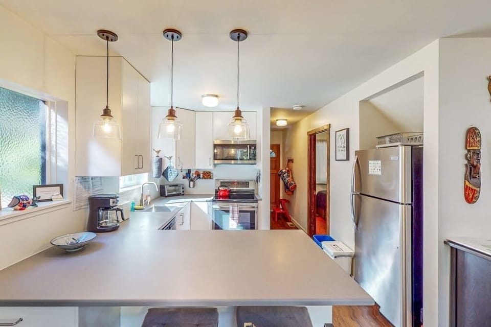 Whip up farm-to-table feasts in your fully equipped kitchen — ample counter space and pendant lighting make cooking feel effortless.
