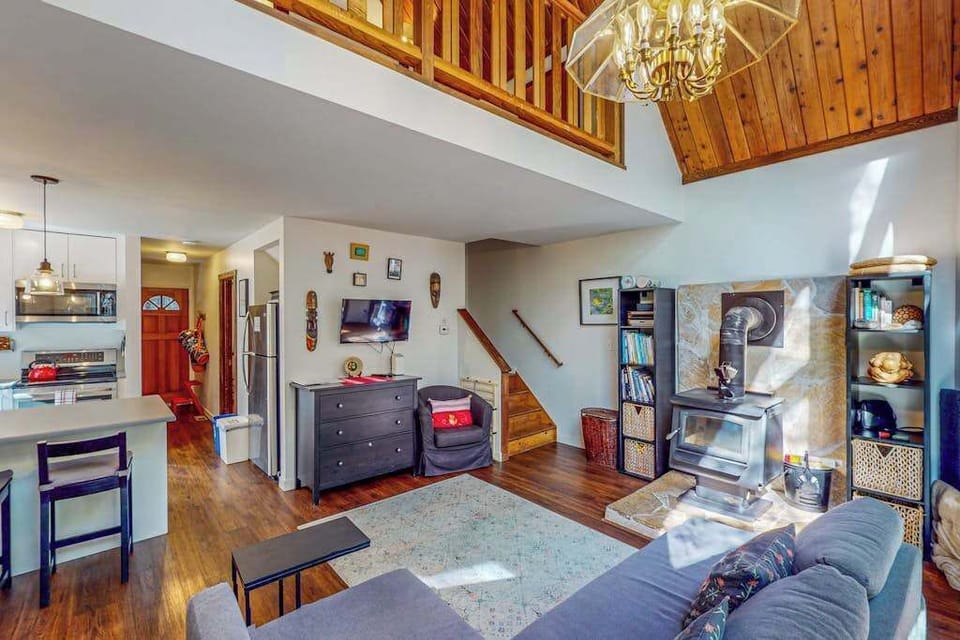 Open-concept living spans both floors — your loft peeks over the railing while the kitchen and cozy TV nook keep everyone connected.