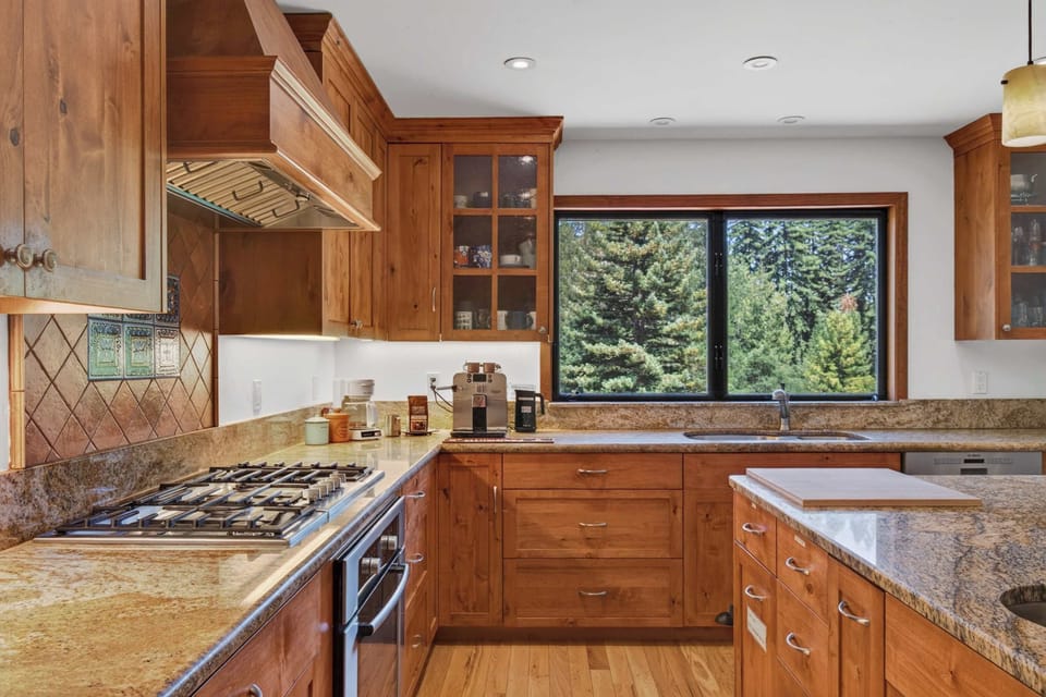Granite counters, a five-burner gas range and forest views out the sink window make cooking here feel like an occasion.