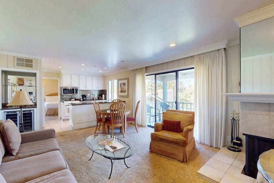 Spread out in your open-concept living space with a full kitchen, wine cooler, and sliding doors that frame the Napa Valley golf course beyond your balcony.