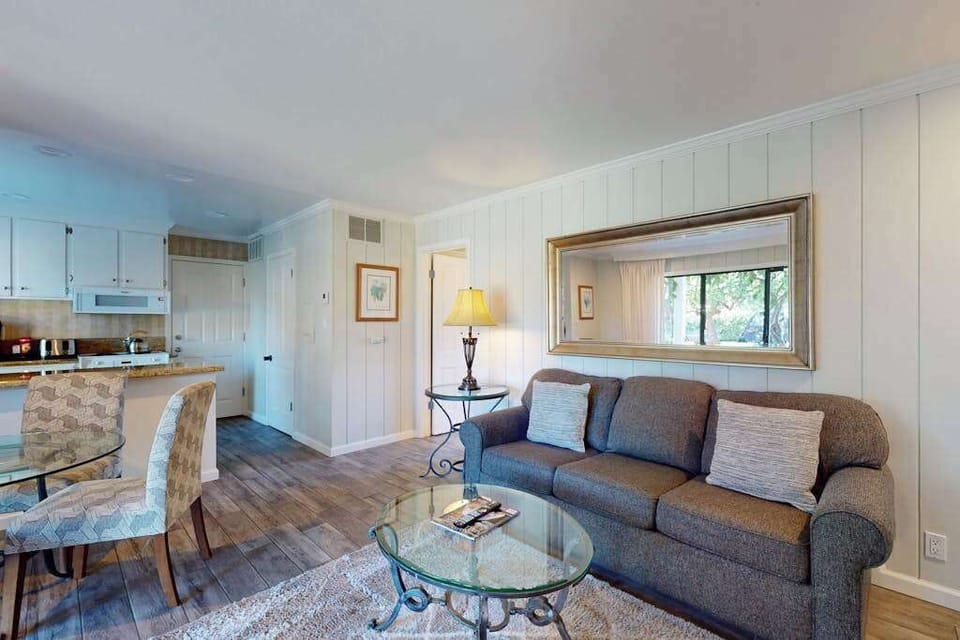 Gather around the glass-topped coffee table in your open-concept living space with kitchen and dining just steps away in your Silverado condo.