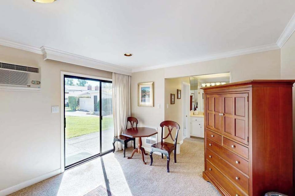 Step from your bedroom directly onto the patio through sliding glass doors — a cherry armoire and bistro table make this Napa hideaway feel like home.