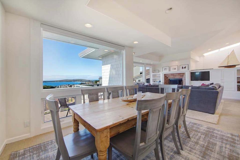 Share memorable meals at the farmhouse-style dining table with stunning ocean views as your backdrop.