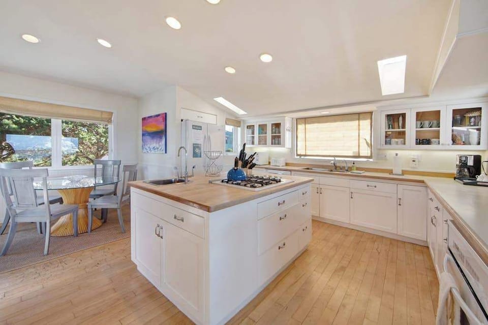 Everything you need awaits in the fully equipped chef's kitchen with skylight, gas range, and ample counter space.