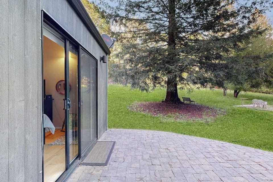 Transition from your bedroom onto the stone patio and into a sprawling private yard shaded by magnificent mature trees.
