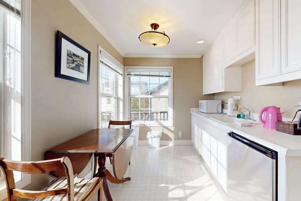 White cabinetry and ample counter space make it easy to prepare charcuterie boards with local Sonoma cheeses and wine.