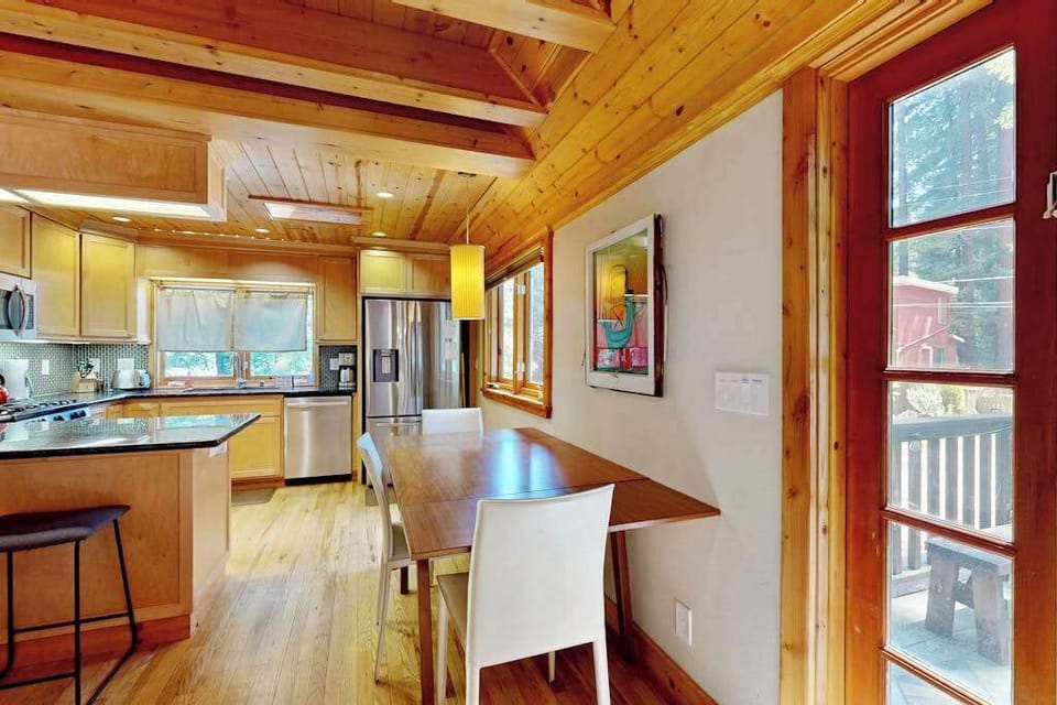 Step from your dining area into a chef-ready kitchen with granite counters and stainless steel appliances — the French door leads straight to your redwood deck.