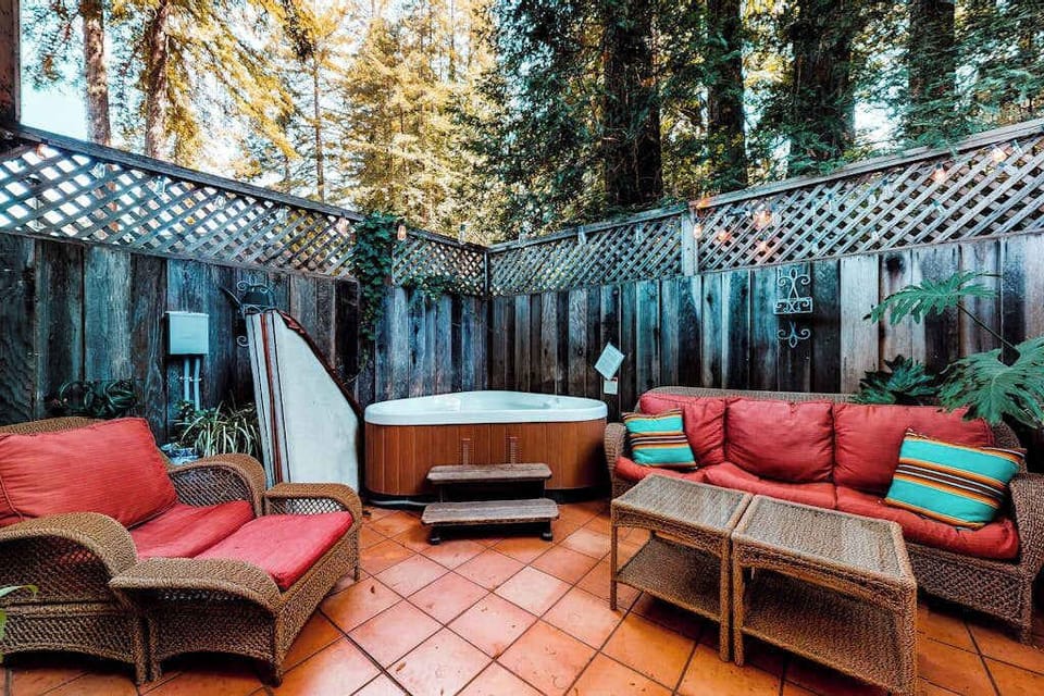 Sink into plush wicker seating beside your private hot tub on the enclosed patio — the perfect way to unwind after a day of Sonoma County wine tasting.