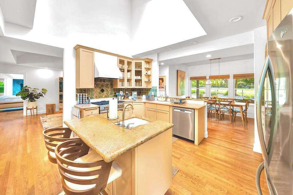 Channel your inner chef in this sun-filled gourmet kitchen — a granite island with bar seating, stainless appliances, and sky-lit ceilings make cooking a pleasure