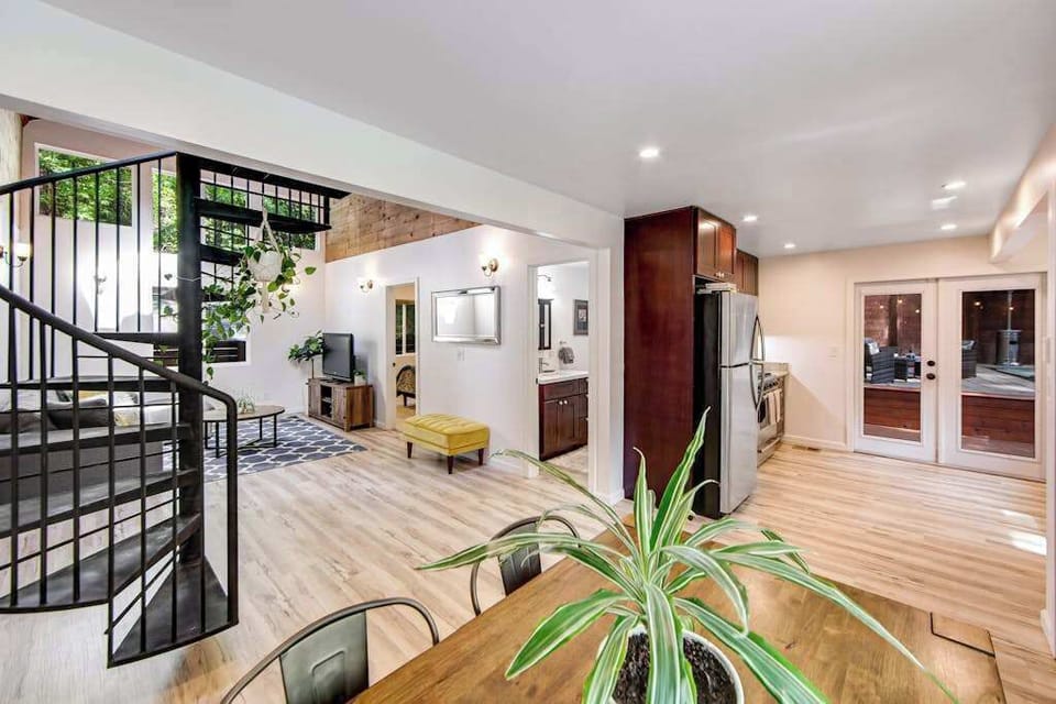 Explore the open-concept main floor where your living area, dining nook, and kitchen connect seamlessly — French doors open directly onto the redwood deck.