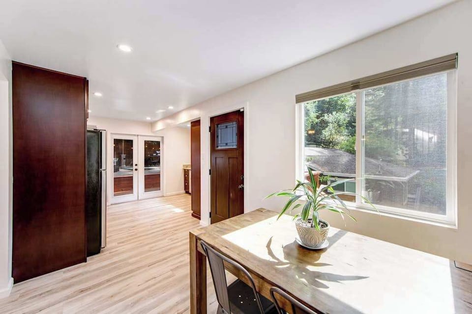 Arrive through your private entrance into a warm hallway with rich wood cabinetry and a picture window overlooking the redwood deck beyond.