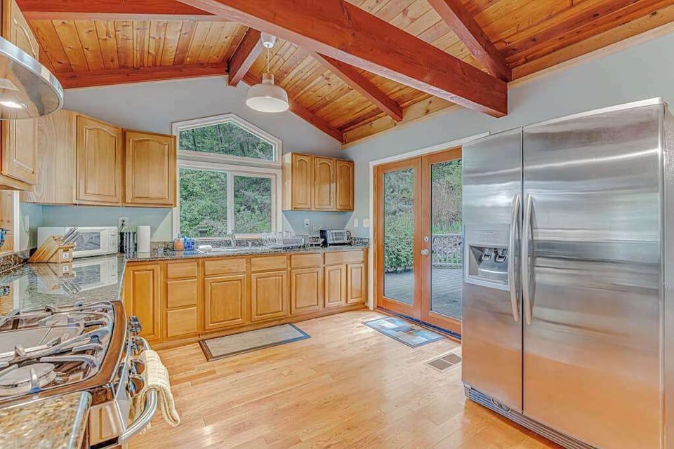 Your kitchen opens to the outdoors through French doors — grab local cheeses from the full-size fridge and head straight to the deck for an al fresco spread.
