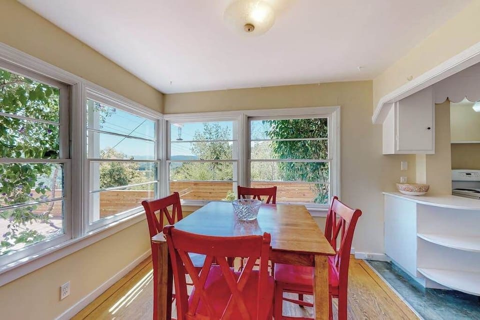 Linger over breakfast at your charming farmhouse dining table — sunlight pours through panoramic windows framing Healdsburg's rolling green hills.