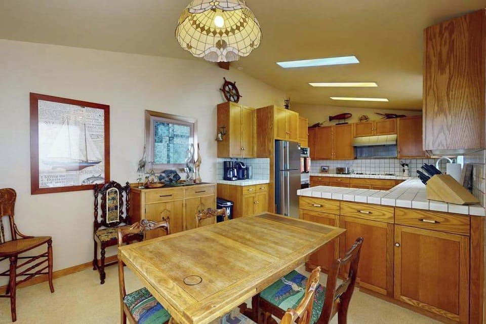 Prepare fresh Bodega Bay seafood in your fully equipped kitchen with a center island, stainless appliances, and warm wood cabinetry