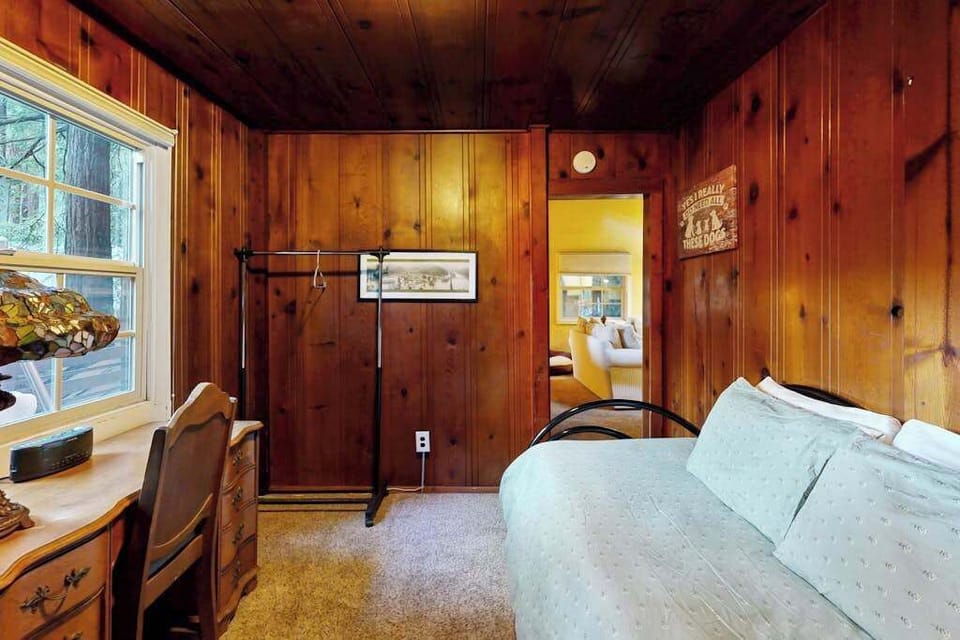 Cozy sleeping quarters with a writing desk let you wind down in peaceful redwood seclusion.