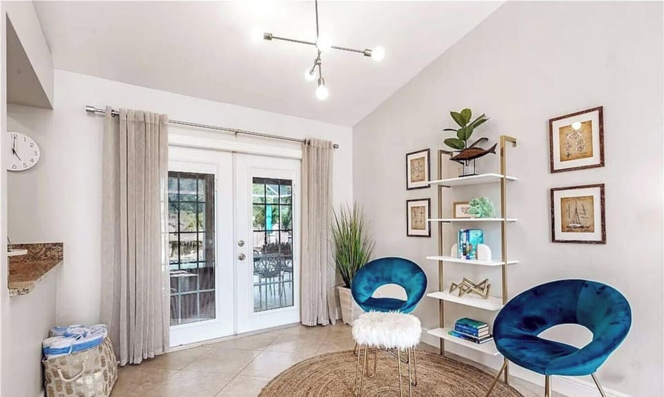 Bright bonus sitting area with comfortable seating and French doors overlooking the outdoor space.
