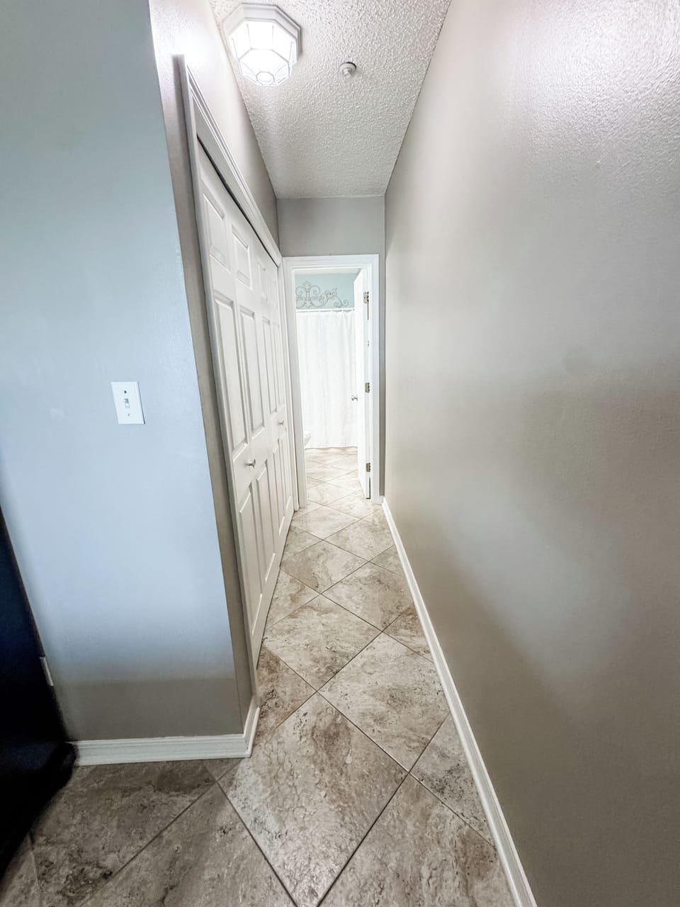 Walkway from the main bedroom into the connecting bathroom. Closet on the left.