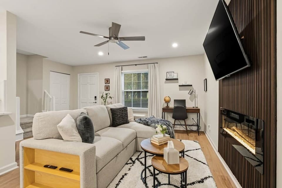 Comfortable living area featuring a beautiful focal wall with electric fireplace that can be used year round for ambiance, and warmth in the winter. Dimmable ceiling lights sets the tone for good conversation or an action packed movie.   