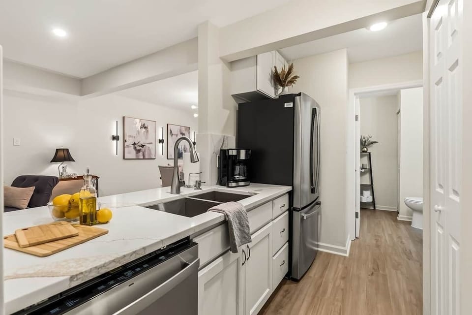 Clean, streamlined, modern kitchen with stainless steel appliances, quartz countertops, and all the cookware essentials to make yourself a home cooked meal...or not!