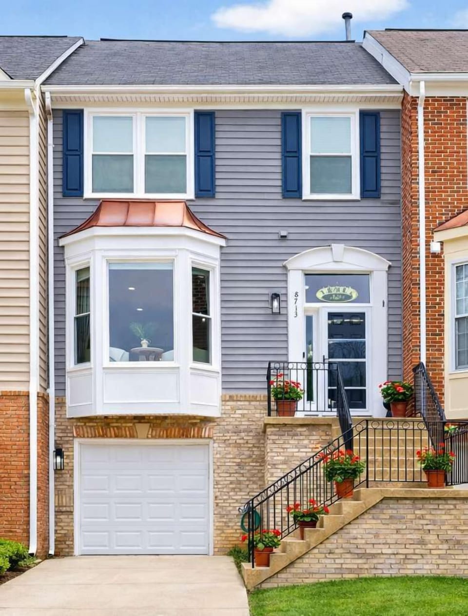 Stylish luxury townhouse with a one-car garage and recent exterior upgrades, including new siding and windows.