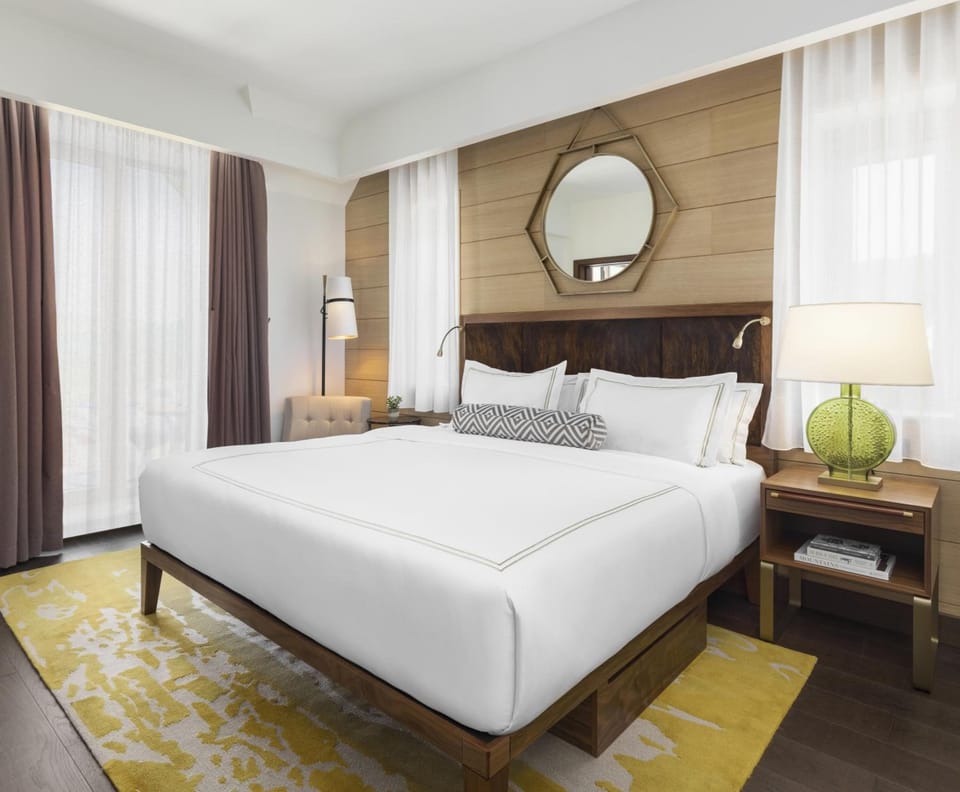 Unwind in a serene king room with warm ambient lighting.