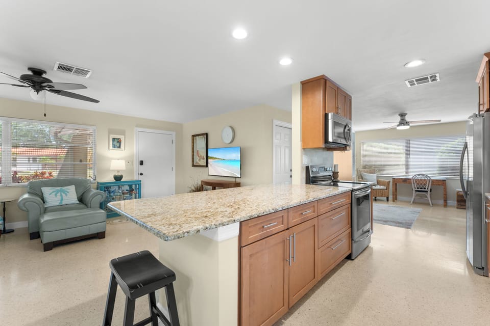 Fully Equipped Kitchen – Includes additional bar seating and stainless steel appliances