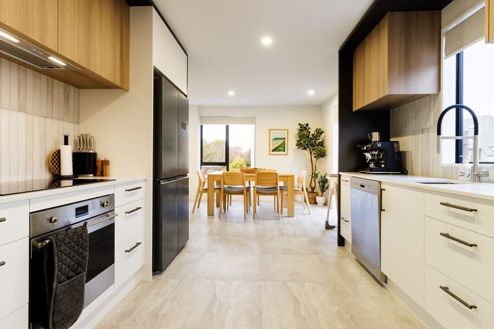 Fully equipped kitchen with modern appliances and a spacious dining area.
