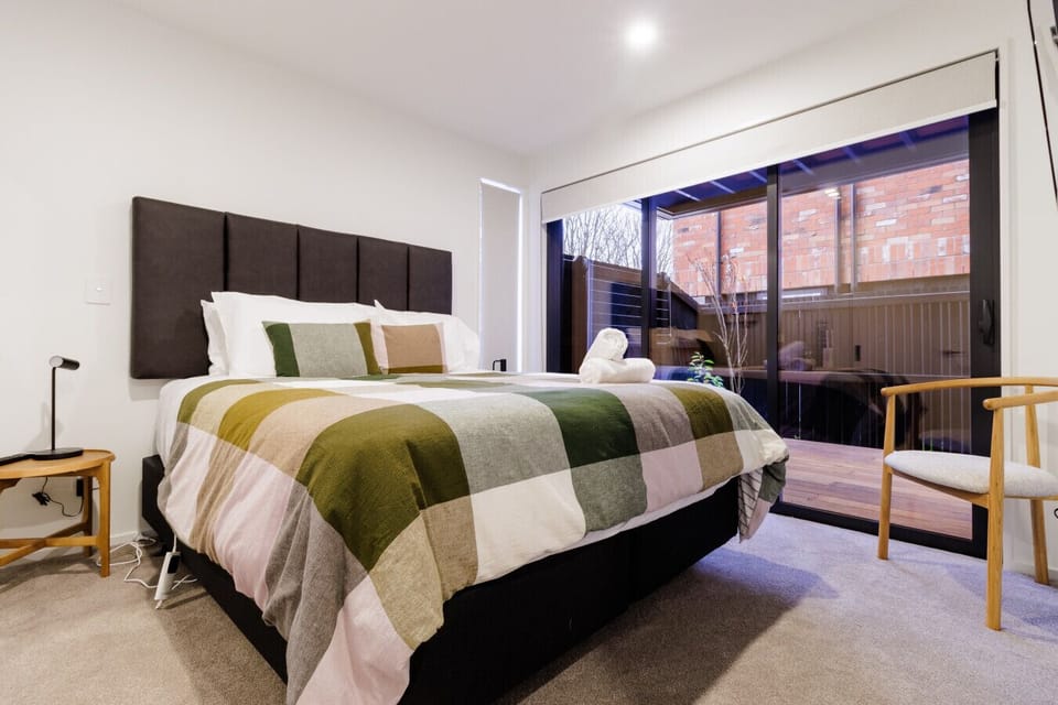 Relaxing bedroom with direct access to outdoor decking and natural light.