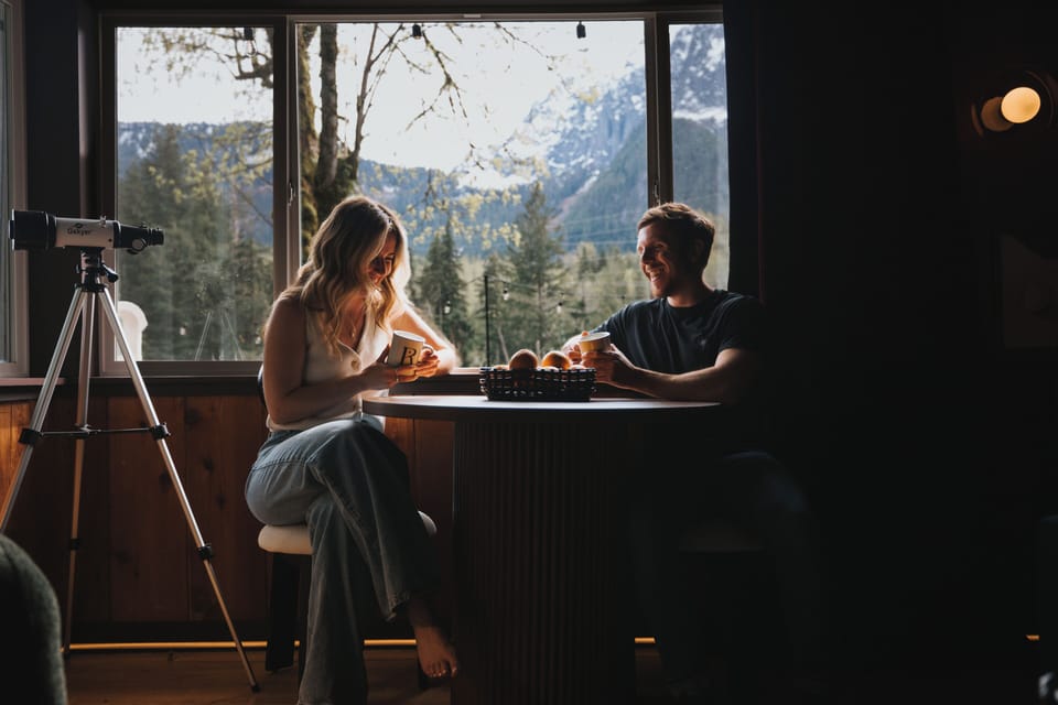 Dining nook with panoramic Index mountain views, natural light, and seating for morning coffee.