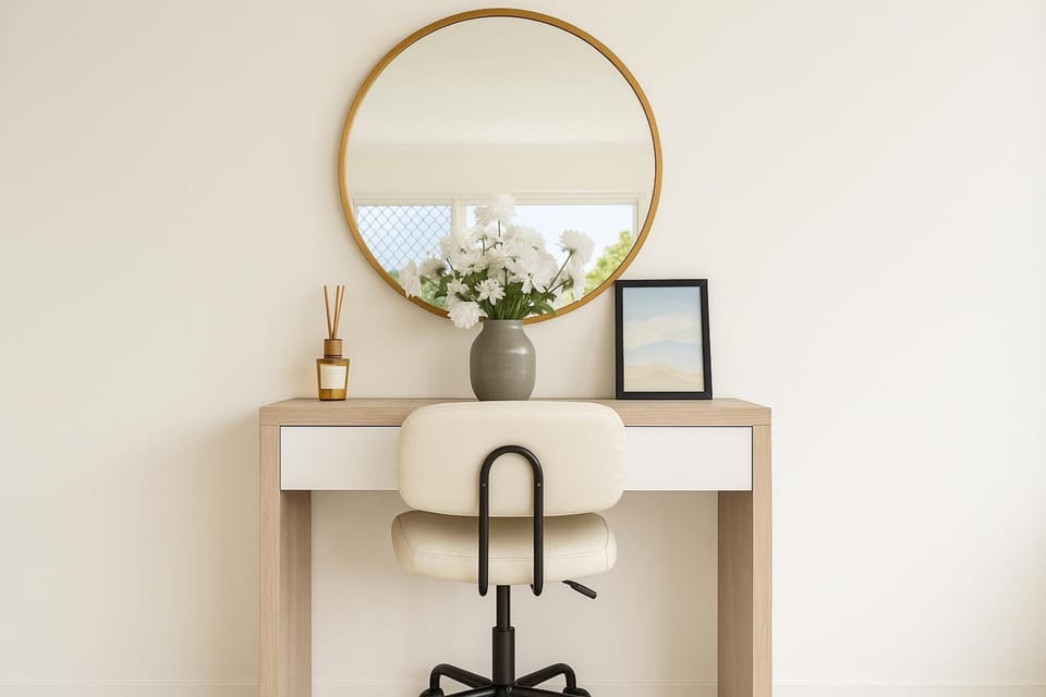 A compact desk space complete with swivel chair - a space for catching up on the news