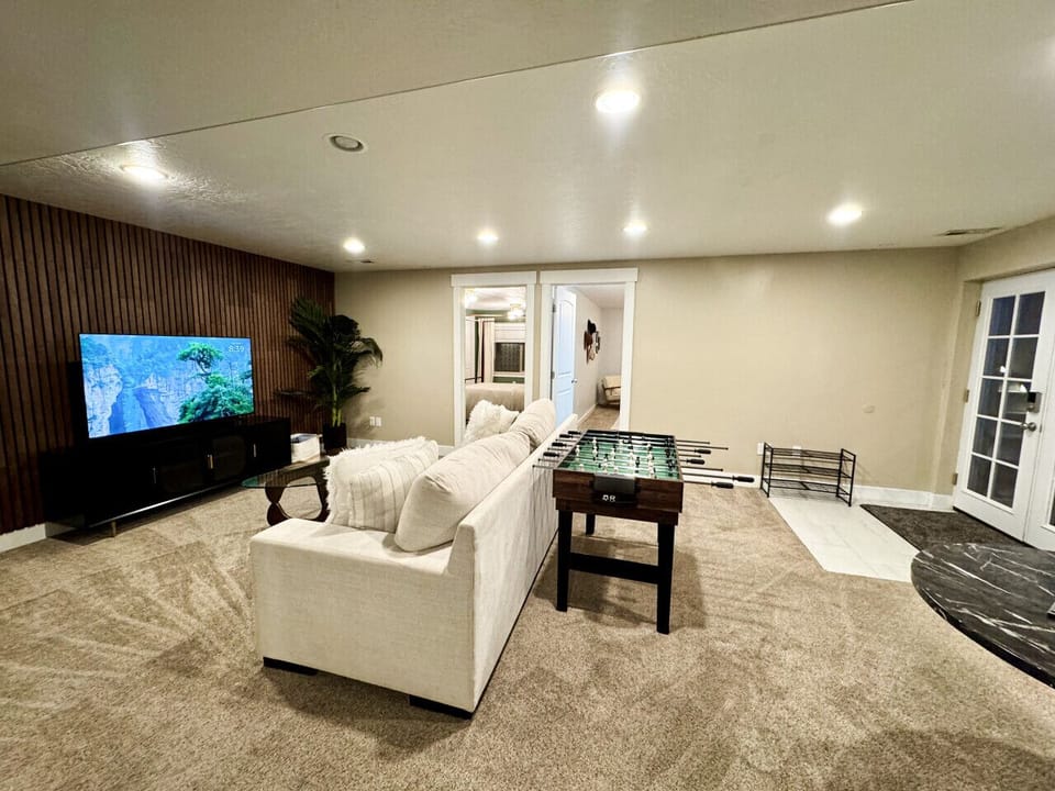Your hangout spot with a smart TV, 3-in-1 foosball table, and couch