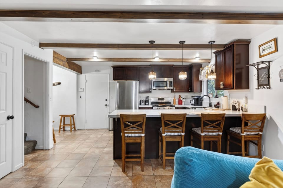 Fully equipped kitchen with spacious island and bar seating.