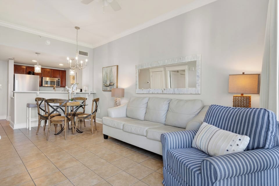 The airy living room features coastal-inspired decor and easy-to-maintain tile flooring.