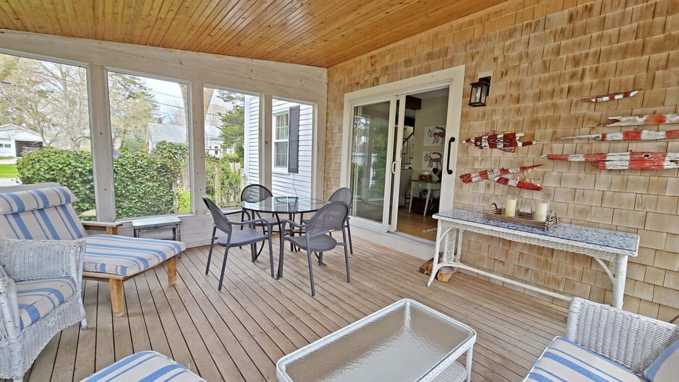 Lovely screen porch with table and seating