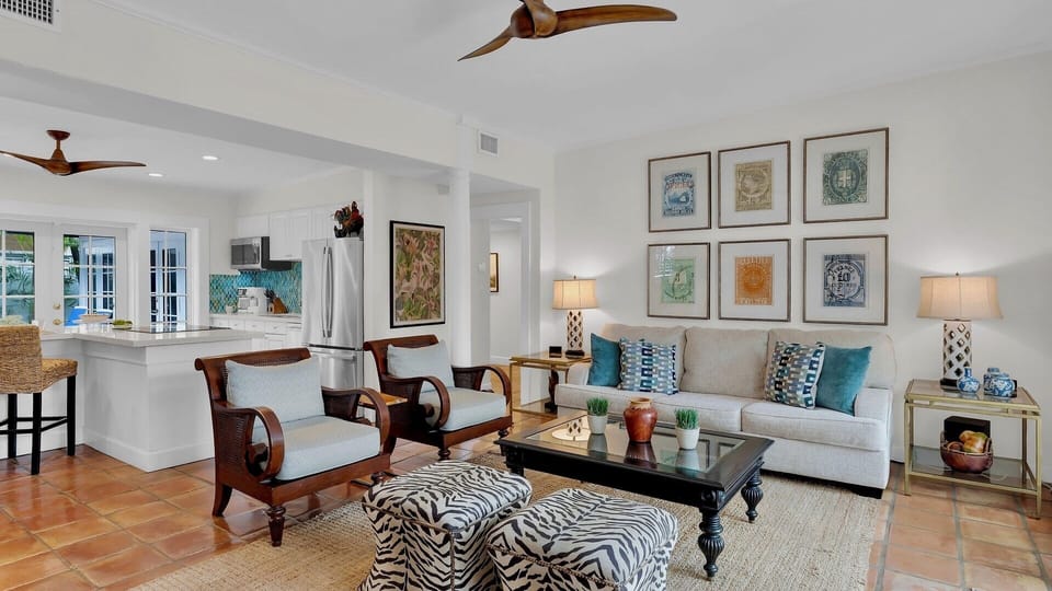 Unwind in your spacious living area with coastal decor, ceiling fans, and an open kitchen—perfect for relaxing after a day of adventure.