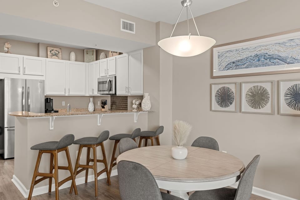 Gather around your open-concept kitchen and dining area, perfect for morning coffee or evening meals with loved ones in a bright, inviting space.