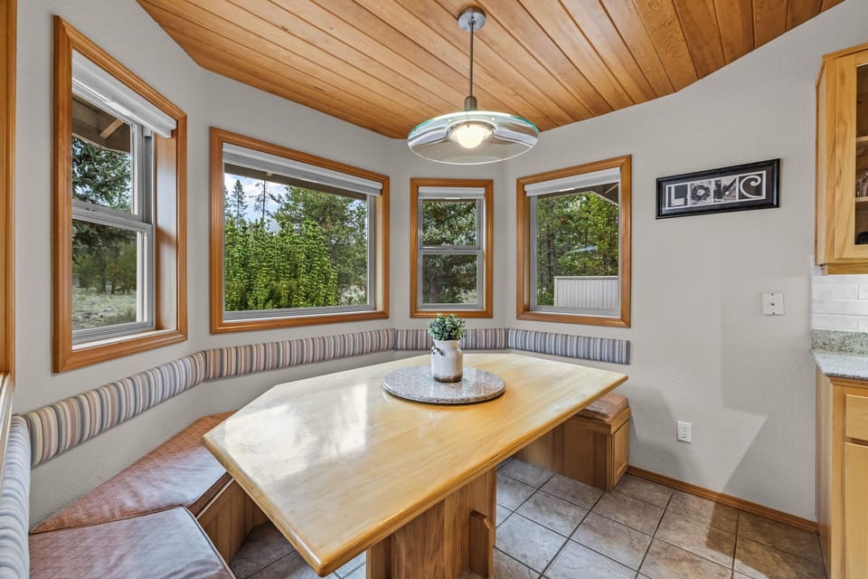 Gather around this cozy breakfast nook where built-in seating and warm wood create the perfect spot for morning coffee.