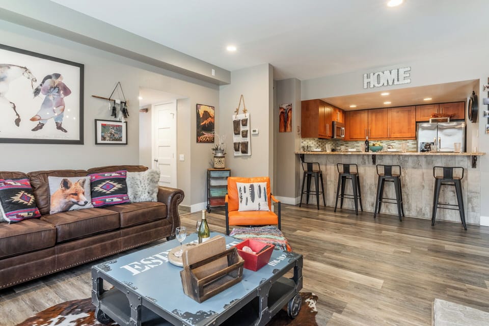 Relax in this beautifully designed open-concept living space where warm wood floors and cozy leather seating invite you to unwind after your adventures.