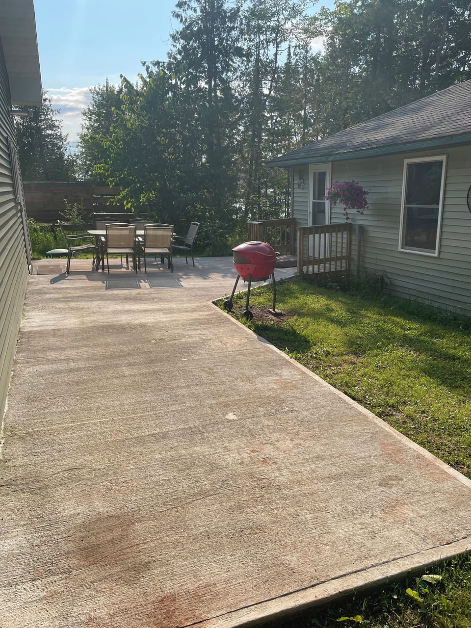 Outside patio area with table and chairs. 