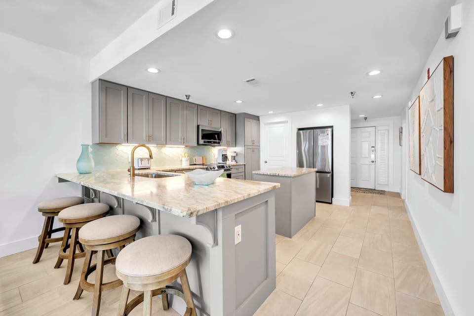 Your modern kitchen awaits with gleaming granite counters, stainless appliances, and a breakfast bar perfect for morning coffee or evening wine.