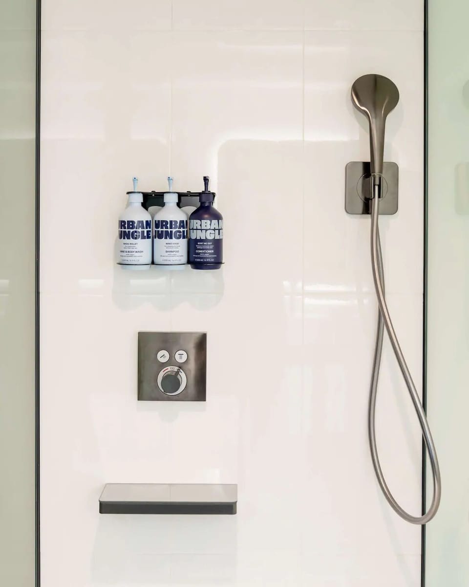 Rinse off under a sleek rainfall-style shower with luxury toiletries.