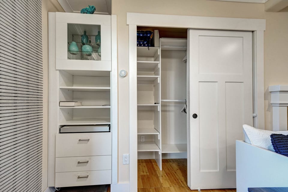 Very spacious lighted closet with extra cushions. Cabinet on the left for misc.