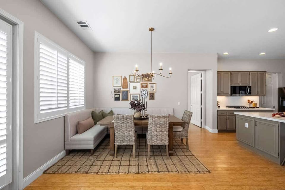 Dining Area: A bright and welcoming space with a spacious table, cozy bench seating, and stylish accents. Perfect for enjoying family meals, or gathering with friends in comfort and style.