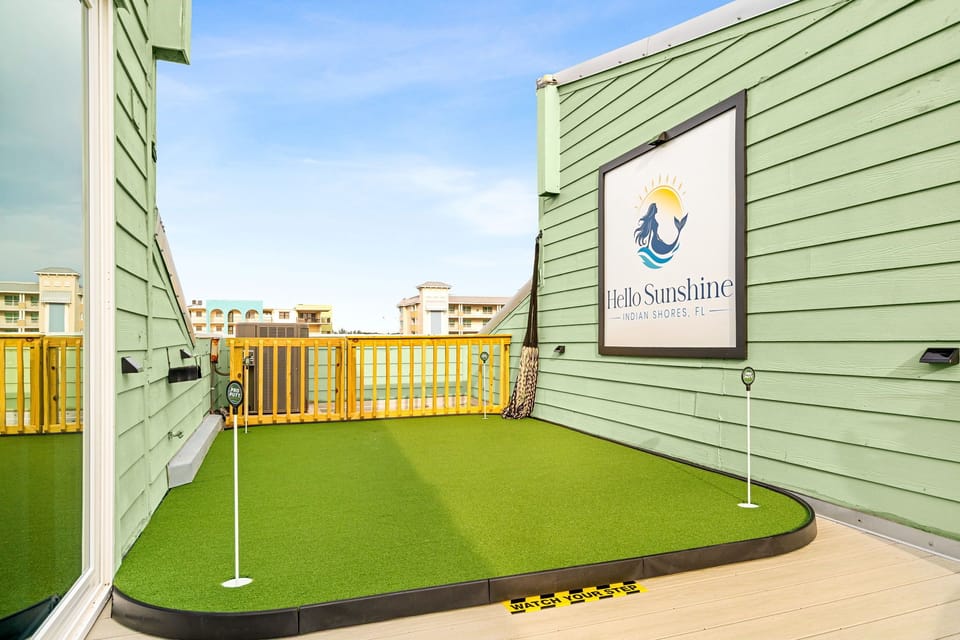 A custom putting green on the roof, Gulf as the backdrop.