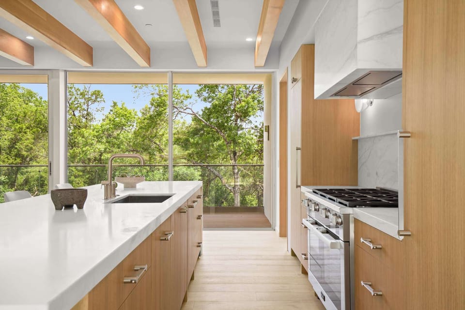 Cook with a view — floor-to-ceiling windows and a fully equipped kitchen make every meal an experience. 