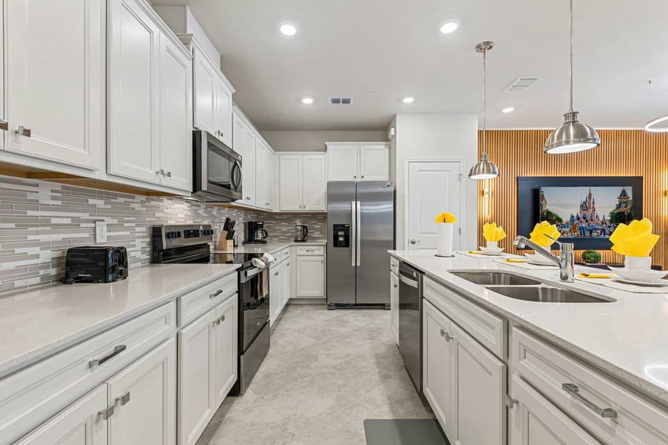 Fully equipped modern kitchen with stainless appliances, a double sink, and generous counter space-cook together while staying connected to the living area.