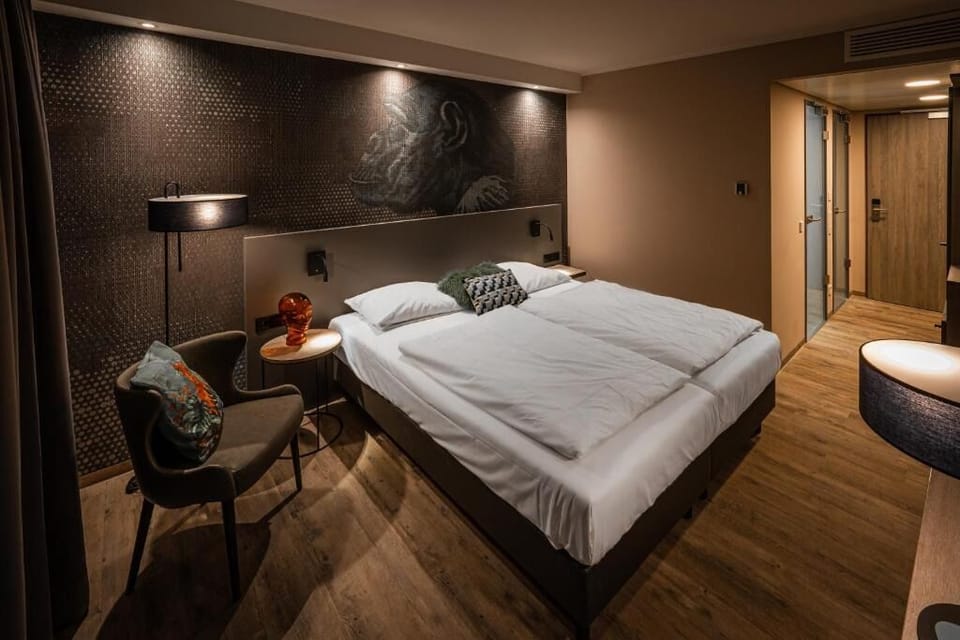 Unwind in a moody, design-led room with plush bedding.